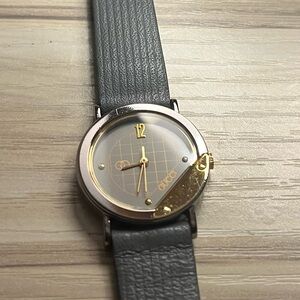Gucci branded watch with grey leather strap and gold details